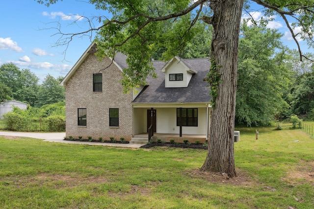 962 Belmont Rd, Clarksville, TN 37040 - view of front facade featuring a porch, a front lawn, brick siding, roof with shingles, and central air condition unit