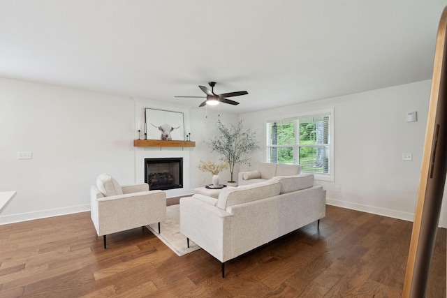 962 Belmont Rd, Clarksville, TN 37040 - living room with a large fireplace, a ceiling fan, wood finished floors, and baseboards