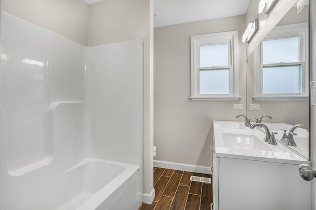 bathroom with double vanity, visible vents, toilet, wood tiled floor, and baseboards