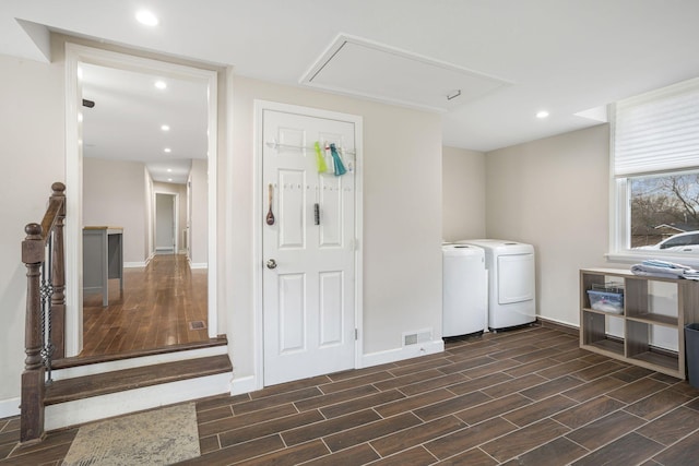 clothes washing area featuring laundry area, washer and clothes dryer, visible vents, and wood tiled floor