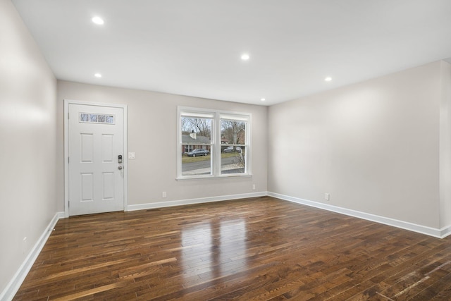 foyer entrance featuring dark wood-style floors, baseboards, and recessed lighting