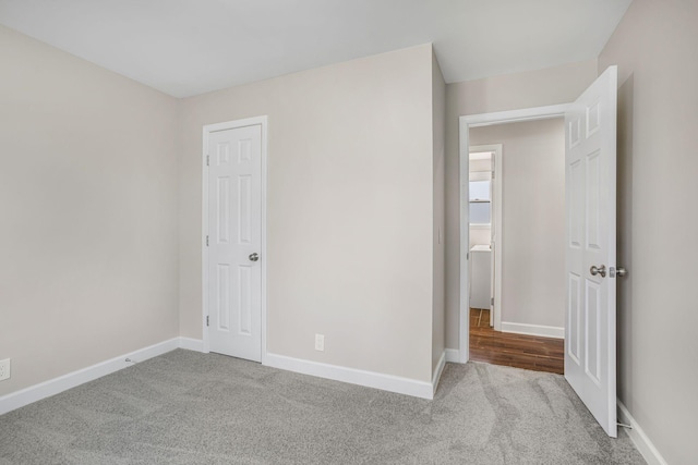 unfurnished bedroom with carpet and baseboards