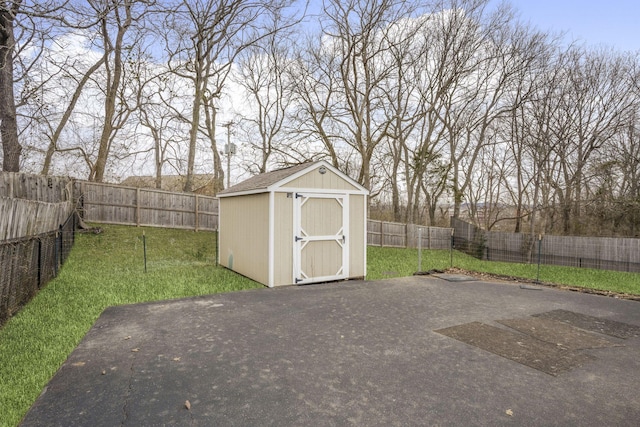 view of yard with a patio, a storage unit, an outdoor structure, and a fenced backyard