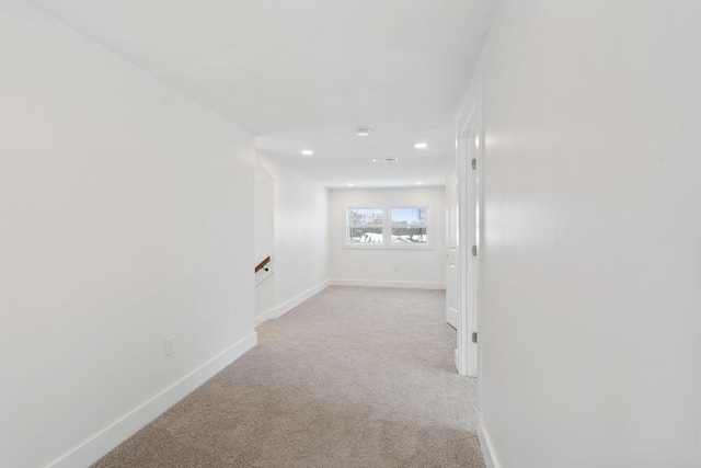 interior space with recessed lighting, baseboards, and light carpet