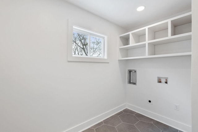 clothes washing area featuring baseboards, laundry area, hookup for a washing machine, hookup for an electric dryer, and dark tile patterned flooring