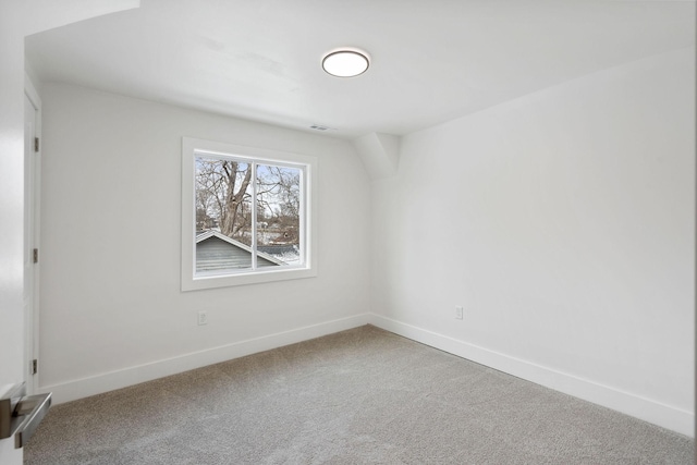 spare room featuring baseboards, carpet floors, and visible vents