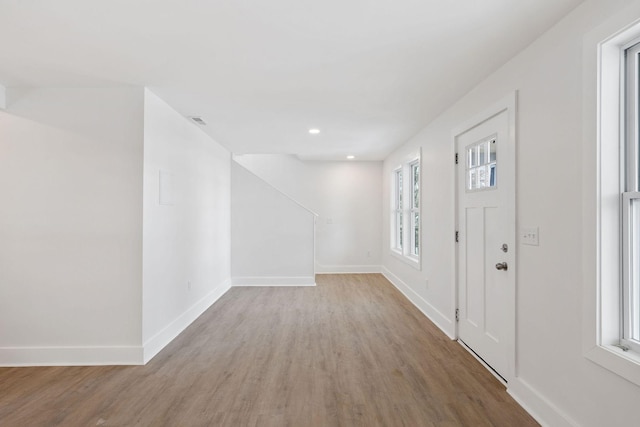 foyer with recessed lighting, visible vents, baseboards, and light wood finished floors