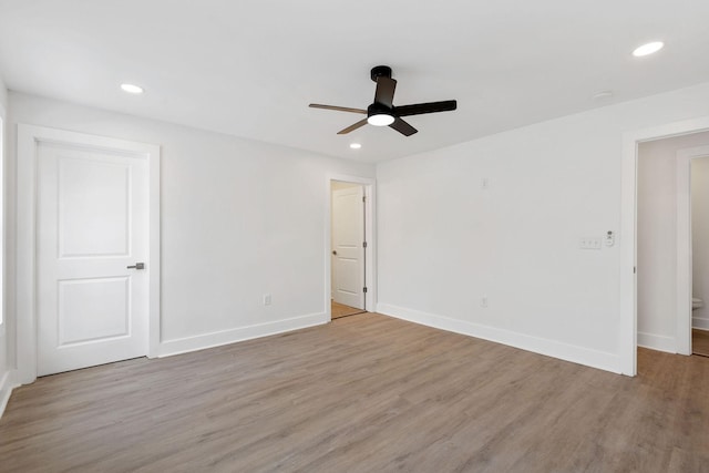 unfurnished room featuring recessed lighting, baseboards, and light wood-style flooring