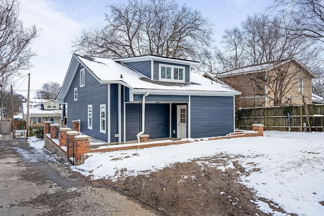 exterior space with covered porch and fence