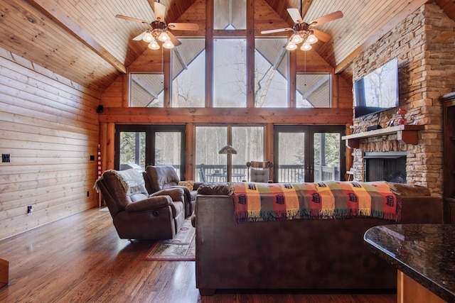 living area featuring wooden ceiling, wood finished floors, and a ceiling fan