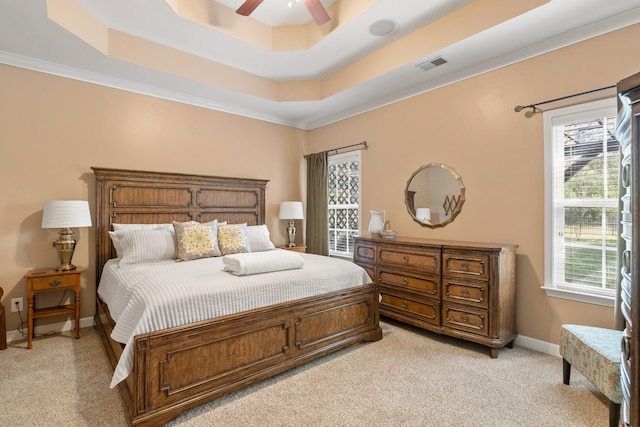 bedroom with baseboards, visible vents, a raised ceiling, a ceiling fan, and light colored carpet