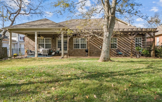 rear view of property with brick siding, fence, a patio, and a yard