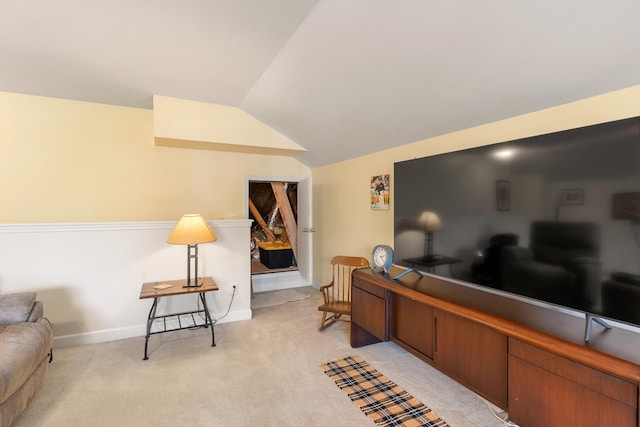 office space with lofted ceiling, light carpet, and baseboards