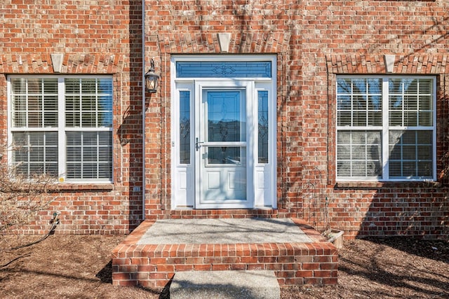 property entrance featuring brick siding