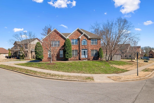 view of front of property with brick siding and a front lawn