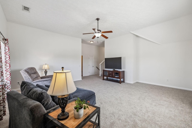 living room featuring visible vents, baseboards, carpet flooring, a textured ceiling, and a ceiling fan