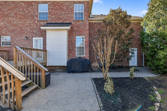 exterior space featuring a patio area and brick siding