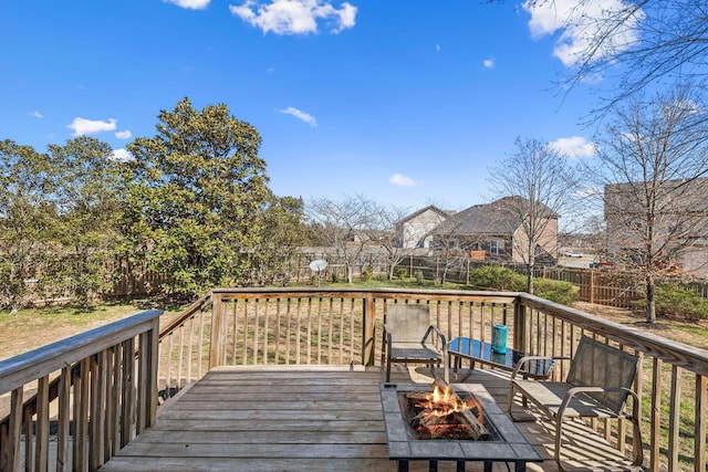 deck featuring a fire pit and a fenced backyard