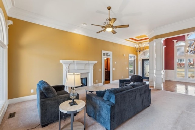 living room with decorative columns, visible vents, crown molding, and a high end fireplace