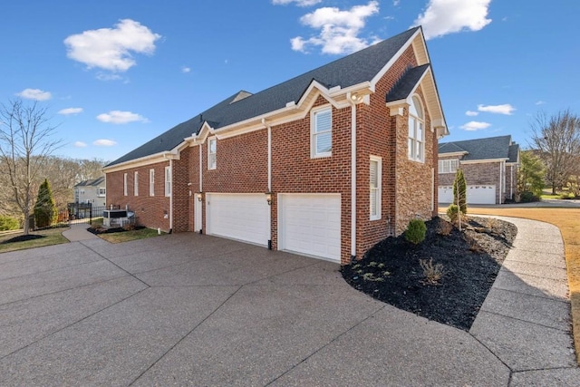 view of property exterior with driveway, a garage, and brick siding