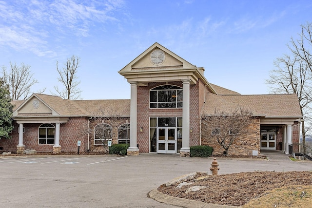 view of building exterior with uncovered parking