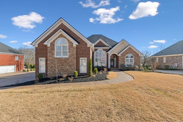 view of front of home with brick siding and a front lawn