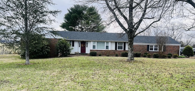 single story home featuring a front yard and brick siding