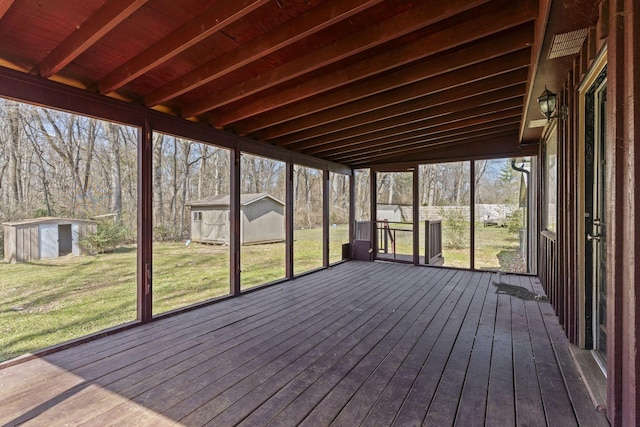 unfurnished sunroom featuring beamed ceiling