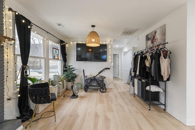 interior space with baseboards, visible vents, and light wood-style floors