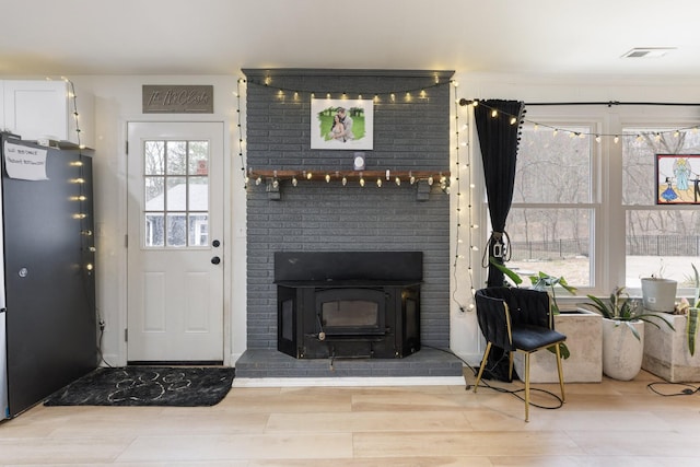 living room featuring visible vents and wood finished floors