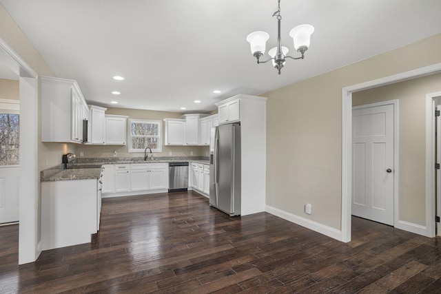 kitchen featuring dark wood finished floors, recessed lighting, a sink, stainless steel appliances, and white cabinets