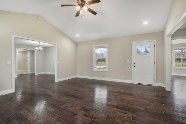 foyer entrance featuring lofted ceiling, a healthy amount of sunlight, dark wood finished floors, and ceiling fan with notable chandelier