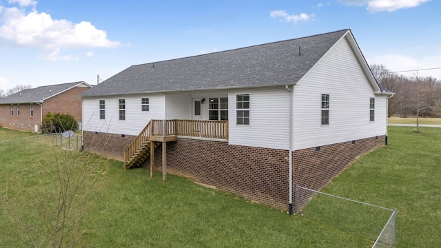 rear view of property featuring a shingled roof, stairway, a yard, and crawl space