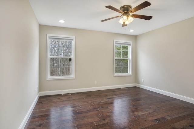 spare room featuring recessed lighting, a ceiling fan, dark wood-type flooring, and baseboards