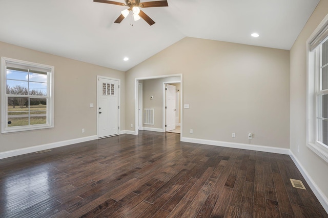 interior space featuring vaulted ceiling, dark wood-style floors, and visible vents