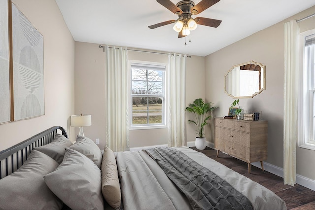 bedroom featuring a ceiling fan, baseboards, and dark wood-style flooring