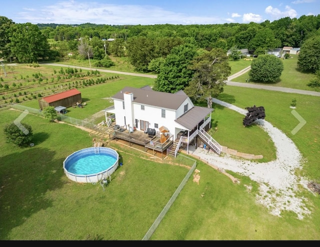 drone / aerial view featuring a rural view and a wooded view