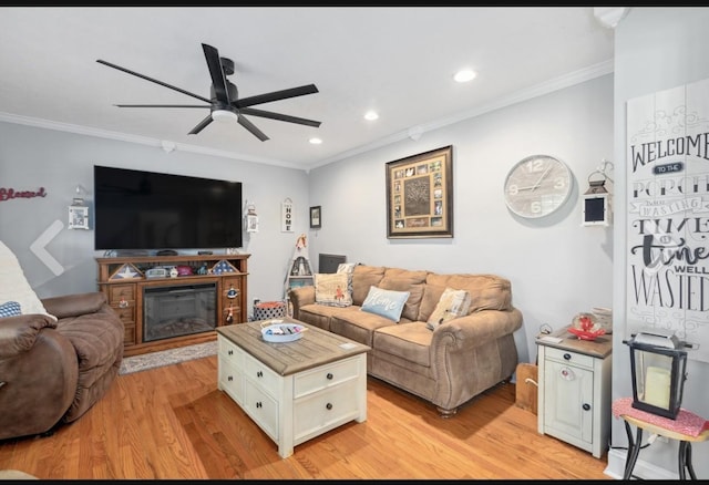 living room with recessed lighting, light wood-style flooring, and crown molding