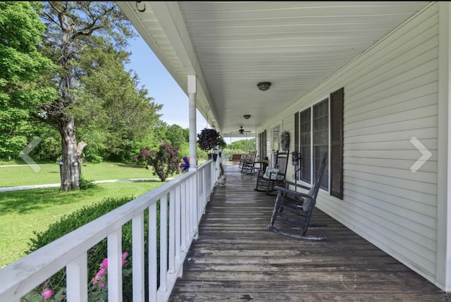 deck with covered porch and a yard