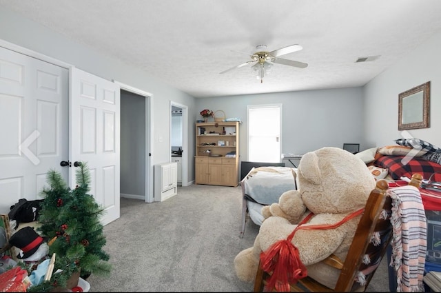 bedroom featuring light carpet, baseboards, visible vents, and a ceiling fan