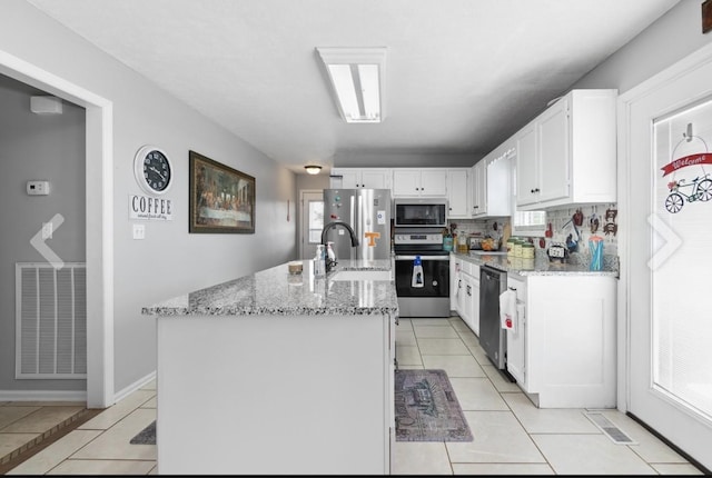 kitchen with white cabinetry, visible vents, appliances with stainless steel finishes, and light tile patterned flooring