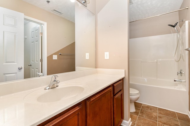 bathroom featuring toilet, visible vents, a textured ceiling, and vanity