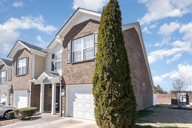 view of front of home with a garage, concrete driveway, brick siding, and stone siding