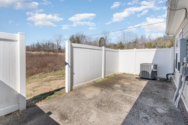 view of yard with central AC, a patio, and a fenced backyard