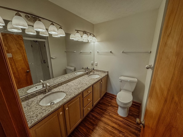 bathroom featuring a sink, toilet, and wood finished floors