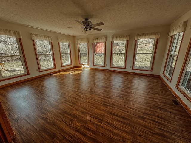 unfurnished sunroom with visible vents and ceiling fan