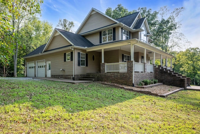 view of front facade featuring an attached garage, driveway, a porch, and a front yard