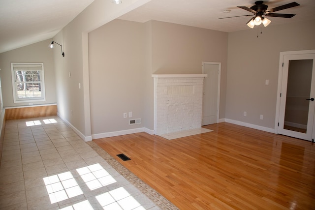 interior space with visible vents, light wood-style flooring, ceiling fan, and vaulted ceiling