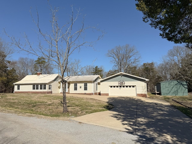 view of front of property with an attached garage, driveway, and a front lawn