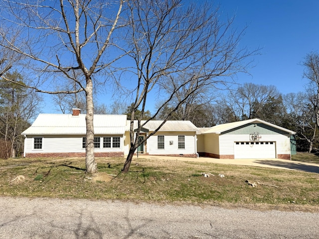 single story home with a front lawn, an attached garage, driveway, and a chimney